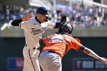 Apr 8, 2023; Minneapolis, Minnesota, USA; Minnesota Twins shortstop Carlos Correa (4) is tagged out at home by Houston Astros catcher Martin Maldonado (15) during the second inning at Target Field. Mandatory Credit: Jeffrey Becker-USA TODAY Sports