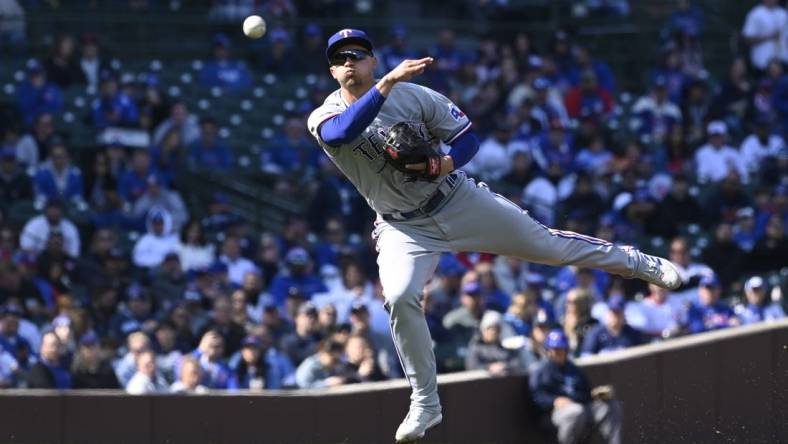 Apr 8, 2023; Chicago, Illinois, USA;  Texas Rangers shortstop Corey Seager (5) throws to first base on a single hit by Chicago Cubs shortstop Dansby Swanson (not pictured) during the first inning at Wrigley Field. Mandatory Credit: Matt Marton-USA TODAY Sports