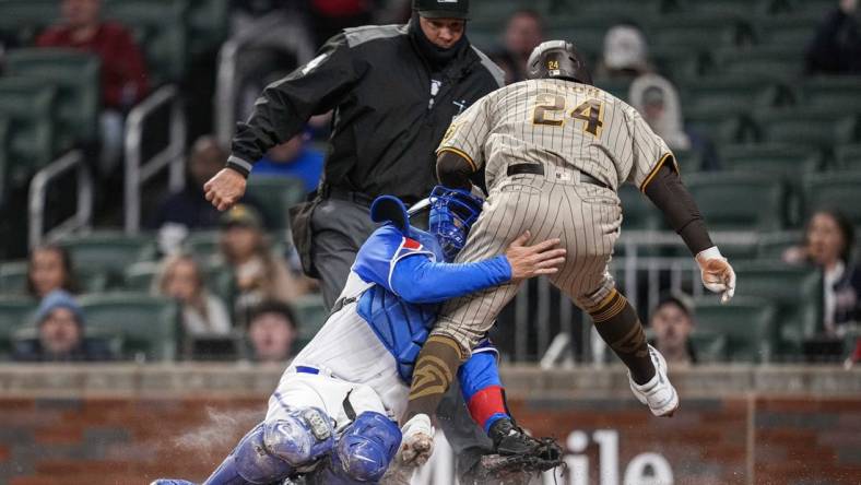 Apr 8, 2023; Cumberland, Georgia, USA; San Diego Padres right fielder Rougned Odor (24) is tagged out on a collision with Atlanta Braves catcher Travis d'Arnaud (16) during the fourth inning  at Truist Park. Mandatory Credit: Dale Zanine-USA TODAY Sports