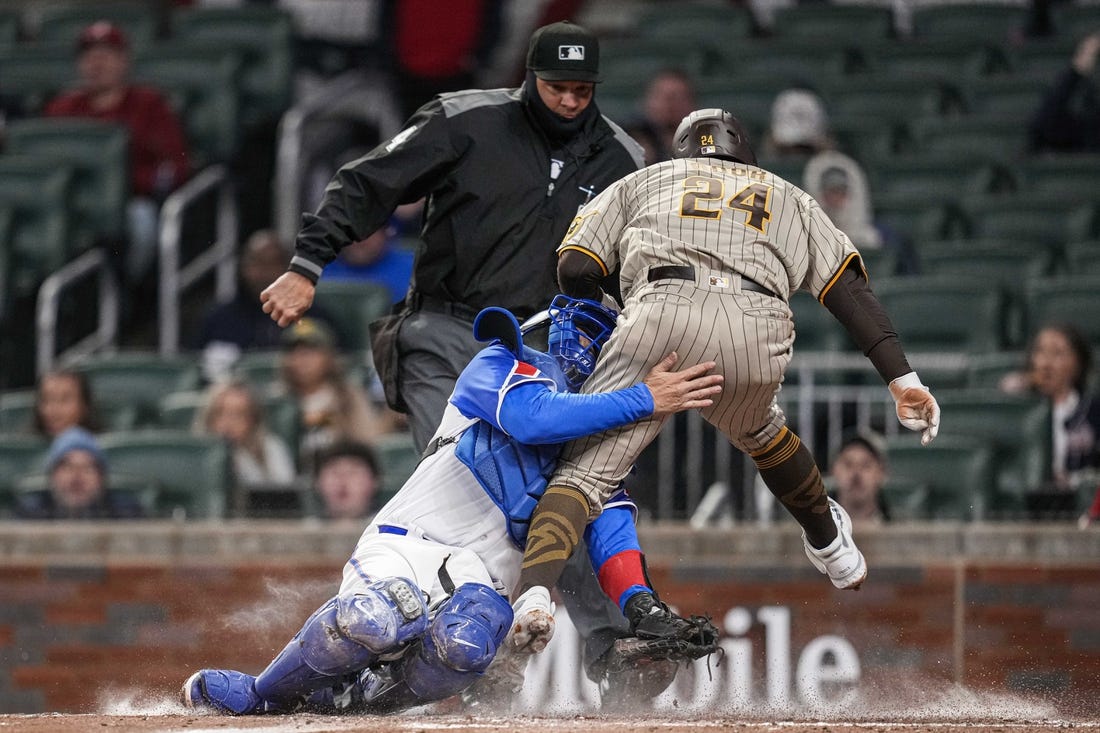 Apr 8, 2023; Cumberland, Georgia, USA; San Diego Padres right fielder Rougned Odor (24) is tagged out on a collision with Atlanta Braves catcher Travis d'Arnaud (16) during the fourth inning  at Truist Park. Mandatory Credit: Dale Zanine-USA TODAY Sports