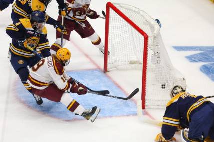 Apr 8, 2023; Tampa, Florida, USA; Minnesota forward John Mittelstadt (19) scores a goal against Quinnipiac in the first period during the national championship game of the 2023 Frozen Four college ice hockey tournament at Amalie Arena. Mandatory Credit: Nathan Ray Seebeck-USA TODAY Sports
