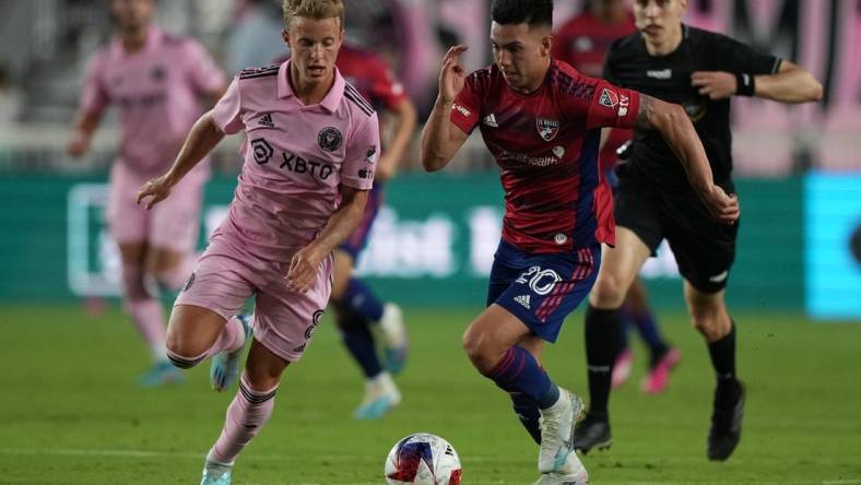 Apr 8, 2023; Fort Lauderdale, Florida, USA; FC Dallas forward Alan Velasco (20) and Inter Miami midfielder Bryce Duke (8) battle for the ball during the first half at DRV PNK Stadium. Mandatory Credit: Eric Espada-USA TODAY Sports