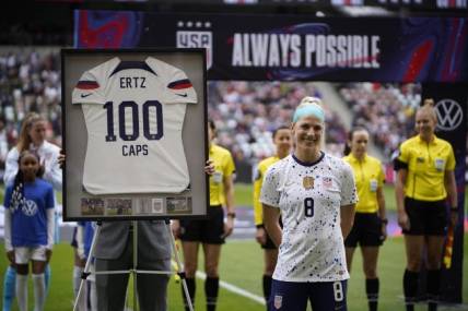 Apr 8, 2023; Austin, Texas, USA;  U.S. Women's National Team midfielder Julie Ertz (8) is celebrated for becoming the 40th U.S. female to hit 100 caps at Q2 Stadium. Mandatory Credit: Dustin Safranek-USA TODAY Sports