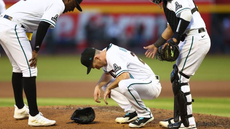 Apr 8, 2023; Phoenix, Arizona, USA; Arizona Diamondbacks pitcher Zach Davies reacts after suffering an injury in the fifth inning against the Los Angeles Dodgers at Chase Field. Mandatory Credit: Mark J. Rebilas-USA TODAY Sports