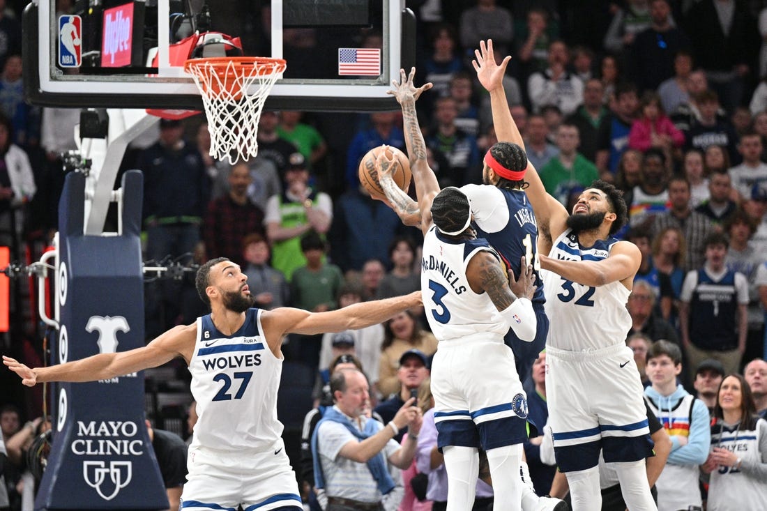 Apr 9, 2023; Minneapolis, Minnesota, USA; New Orleans Pelicans forward Brandon Ingram (14) goes to the basket as Minnesota Timberwolves center Karl-Anthony Towns (32), forward Jaden McDaniels (3) and center Rudy Gobert (27) defend during the first quarter at Target Center. Mandatory Credit: Jeffrey Becker-USA TODAY Sports