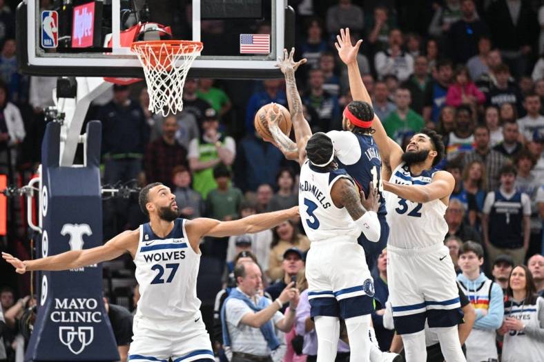 Apr 9, 2023; Minneapolis, Minnesota, USA; New Orleans Pelicans forward Brandon Ingram (14) goes to the basket as Minnesota Timberwolves center Karl-Anthony Towns (32), forward Jaden McDaniels (3) and center Rudy Gobert (27) defend during the first quarter at Target Center. Mandatory Credit: Jeffrey Becker-USA TODAY Sports