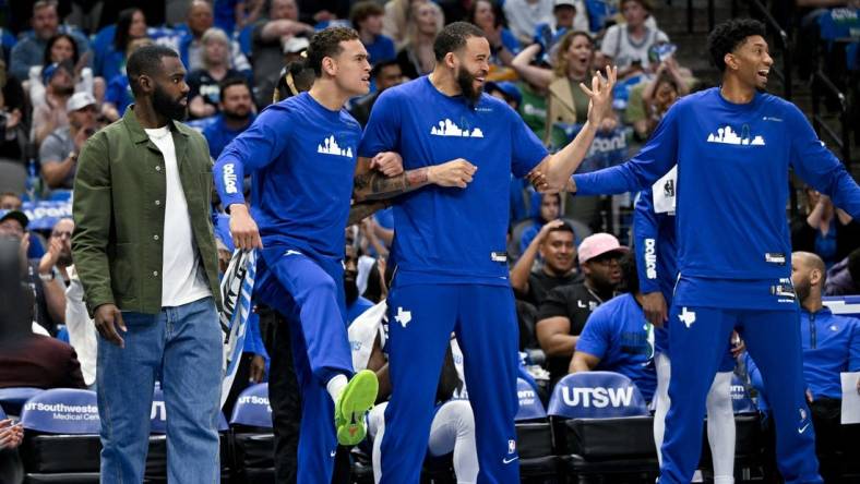 Apr 9, 2023; Dallas, Texas, USA; Dallas Mavericks forward Tim Hardaway Jr. (11) and center Dwight Powell (7) and center JaVale McGee (00) and forward Christian Wood (35) celebrate on the team bench during the second quarter against the San Antonio Spurs at the American Airlines Center. Mandatory Credit: Jerome Miron-USA TODAY Sports