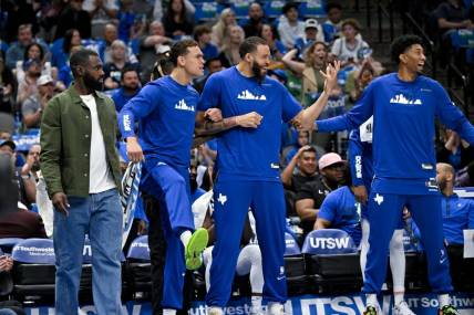 Apr 9, 2023; Dallas, Texas, USA; Dallas Mavericks forward Tim Hardaway Jr. (11) and center Dwight Powell (7) and center JaVale McGee (00) and forward Christian Wood (35) celebrate on the team bench during the second quarter against the San Antonio Spurs at the American Airlines Center. Mandatory Credit: Jerome Miron-USA TODAY Sports