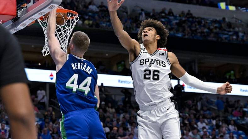 Apr 9, 2023; Dallas, Texas, USA; Dallas Mavericks forward Davis Bertans (44) dunks the ball past San Antonio Spurs forward Dominick Barlow (26) during the second quarter at the American Airlines Center. Mandatory Credit: Jerome Miron-USA TODAY Sports