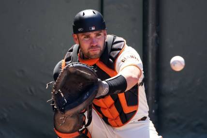 Apr 9, 2023; San Francisco, California, USA; San Francisco Giants catcher Austin Wynns (14) warms up before the game against the Kansas City Royals at Oracle Park. Mandatory Credit: Darren Yamashita-USA TODAY Sports