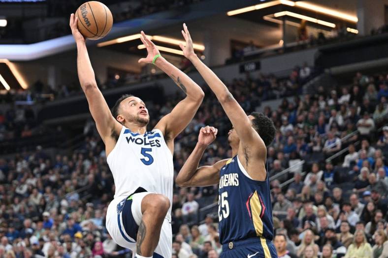 Apr 9, 2023; Minneapolis, Minnesota, USA; Minnesota Timberwolves forward Kyle Anderson (5) goes to the basket as New Orleans Pelicans guard Trey Murphy III (25) defends during the second quarter at Target Center. Mandatory Credit: Jeffrey Becker-USA TODAY Sports