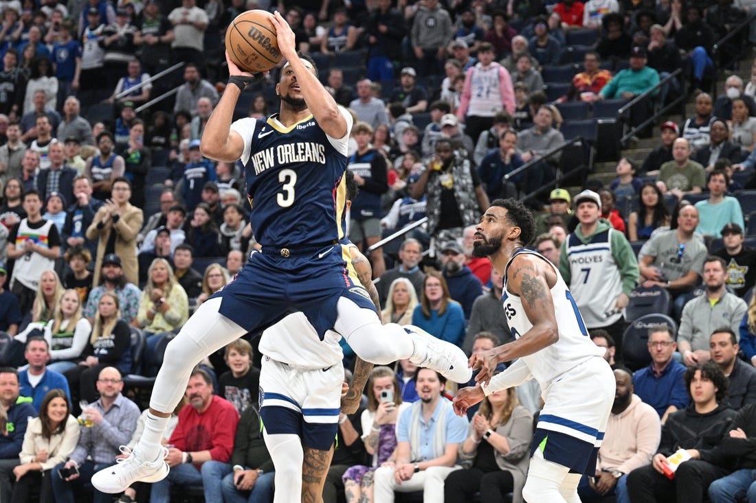 Apr 9, 2023; Minneapolis, Minnesota, USA; New Orleans Pelicans guard CJ McCollum (3) shoots the ball as Minnesota Timberwolves guard Mike Conley (10) looks on during the third quarter at Target Center. Mandatory Credit: Jeffrey Becker-USA TODAY Sports