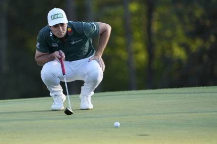 Apr 9, 2023; Augusta, Georgia, USA; Viktor Hovland lines up his putt on the 18th green during the final round of The Masters golf tournament. Mandatory Credit: Danielle Parhizkaran-USA TODAY Network