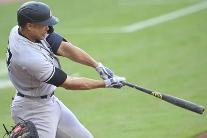 Apr 10, 2023; Cleveland, Ohio, USA; New York Yankees right fielder Giancarlo Stanton (27) hits a two-RBI double in the first inning against the Cleveland Guardians at Progressive Field. Mandatory Credit: David Richard-USA TODAY Sports