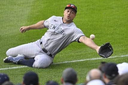 Apr 10, 2023; Cleveland, Ohio, USA; New York Yankees right fielder Giancarlo Stanton (27) reaches for a ball that landed foul in the second inning against the Cleveland Guardians at Progressive Field. Mandatory Credit: David Richard-USA TODAY Sports