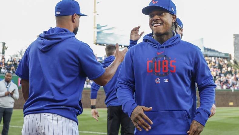 Apr 10, 2023; Chicago, Illinois, USA; Chicago Cubs pitcher Marcus Stroman (R) smiles before a baseball game against the Seattle Mariners at Wrigley Field. Mandatory Credit: Kamil Krzaczynski-USA TODAY Sports