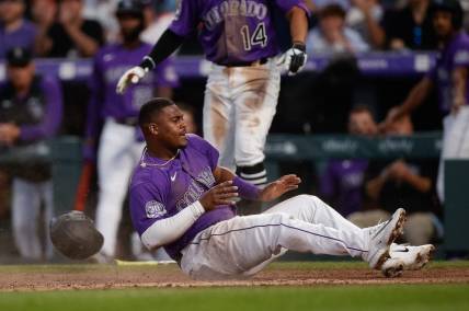 Apr 10, 2023; Denver, Colorado, USA; Colorado Rockies third baseman Elehuris Montero (44) slides into home after being driven in on an RBI in the fourth inning against the St. Louis Cardinals at Coors Field. Mandatory Credit: Isaiah J. Downing-USA TODAY Sports