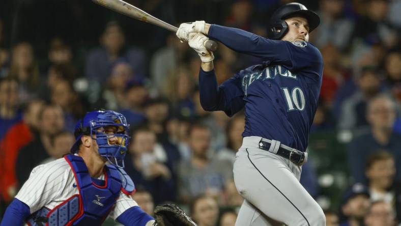 Apr 10, 2023; Chicago, Illinois, USA; Seattle Mariners left fielder Jarred Kelenic (10) hits a solo home run against the Chicago Cubs during the ninth inning at Wrigley Field. Mandatory Credit: Kamil Krzaczynski-USA TODAY Sports