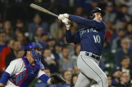 Apr 10, 2023; Chicago, Illinois, USA; Seattle Mariners left fielder Jarred Kelenic (10) hits a solo home run against the Chicago Cubs during the ninth inning at Wrigley Field. Mandatory Credit: Kamil Krzaczynski-USA TODAY Sports