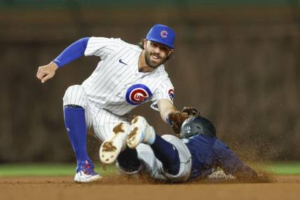 Apr 10, 2023; Chicago, Illinois, USA; Chicago Cubs shortstop Dansby Swanson (7) tags out Seattle Mariners second baseman Kolten Wong (16) as he tries to steal second base during the ninth inning at Wrigley Field. Mandatory Credit: Kamil Krzaczynski-USA TODAY Sports