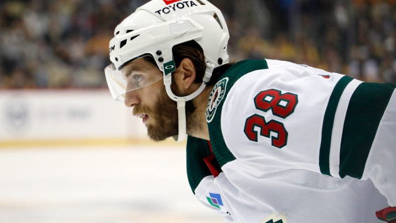 Apr 6, 2023; Pittsburgh, Pennsylvania, USA;  Minnesota Wild right wing Ryan Hartman (38) looks on at the face-off circle against the Pittsburgh Penguins during the first period at PPG Paints Arena. Mandatory Credit: Charles LeClaire-USA TODAY Sports