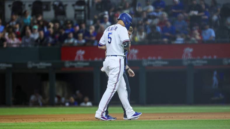 Apr 11, 2023; Arlington, Texas, USA;  Texas Rangers shortstop Corey Seager (5) leaves the game with an injury during the fifth inning against the Kansas City Royals at Globe Life Field. Mandatory Credit: Kevin Jairaj-USA TODAY Sports