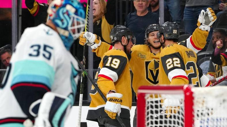 Apr 11, 2023; Las Vegas, Nevada, USA; Vegas Golden Knights right wing Michael Amadio (22) celebrates with Vegas Golden Knights right wing Reilly Smith (19) and Vegas Golden Knights center William Karlsson (71) after scoring against the Seattle Kraken during the second period at T-Mobile Arena. Mandatory Credit: Stephen R. Sylvanie-USA TODAY Sports