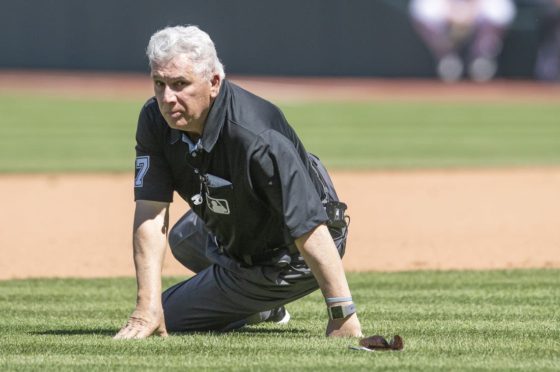 Apr 12, 2023; Cleveland, Ohio, USA; Umpire Larry Vanover (27) gets up after being hit with the baseball during a play in the fifth inning of the game between the Cleveland Guardians and the New York Yankees at Progressive Field. Mandatory Credit: Ken Blaze-USA TODAY Sports