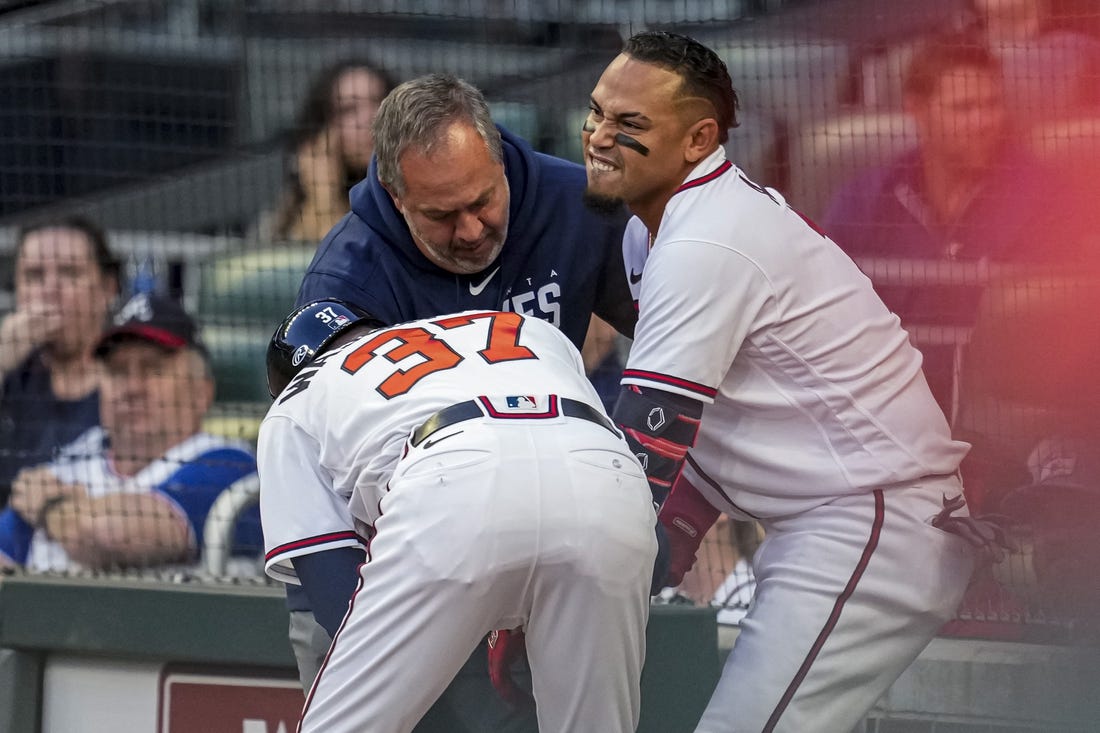 Apr 12, 2023; Cumberland, Georgia, USA; Atlanta Braves shortstop Orlando Arcia (11) is checked after being hit by a pitch against the Cincinnati Reds during the second inning at Truist Park. Mandatory Credit: Dale Zanine-USA TODAY Sports