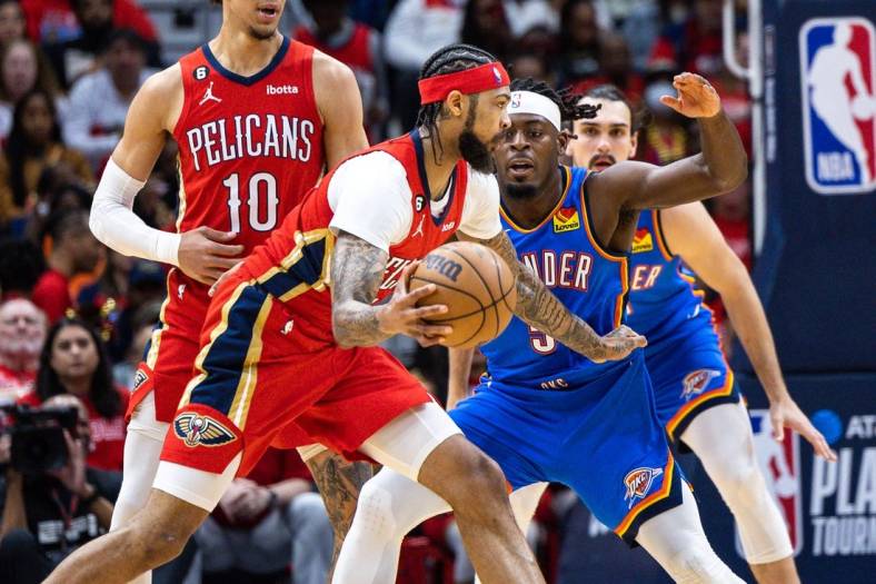 Apr 12, 2023; New Orleans, Louisiana, USA; New Orleans Pelicans forward Brandon Ingram (14) dribbles against Oklahoma City Thunder guard Luguentz Dort (5) during the first half at Smoothie King Center. Mandatory Credit: Stephen Lew-USA TODAY Sports
