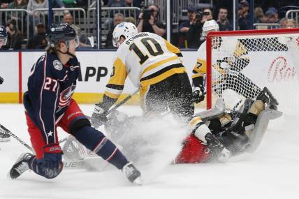 Apr 13, 2023; Columbus, Ohio, USA; Columbus Blue Jackets goalie Michael Hutchinson (31) makes a save as Pittsburgh Penguins left wing Drew O'Connor (10) looks for a rebound during the first period at Nationwide Arena. Mandatory Credit: Russell LaBounty-USA TODAY Sports
