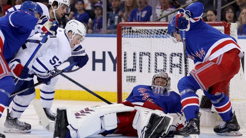 Apr 13, 2023; New York, New York, USA; New York Rangers goaltender Jaroslav Halak (41) makes a save against Toronto Maple Leafs center Noel Acciari (52) and center Auston Matthews (34) during the second period at Madison Square Garden. Mandatory Credit: Brad Penner-USA TODAY Sports