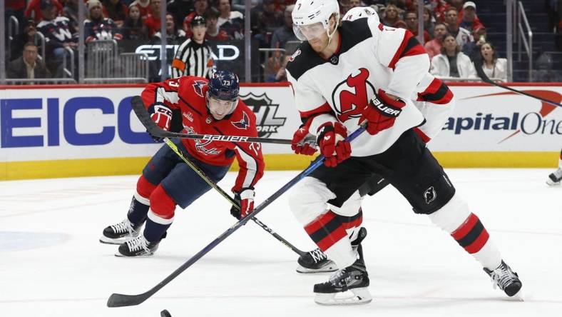 Apr 13, 2023; Washington, District of Columbia, USA; New Jersey Devils defenseman Dougie Hamilton (7) skates with the puck as Washington Capitals left wing Conor Sheary (73) chases in the first period at Capital One Arena. Mandatory Credit: Geoff Burke-USA TODAY Sports