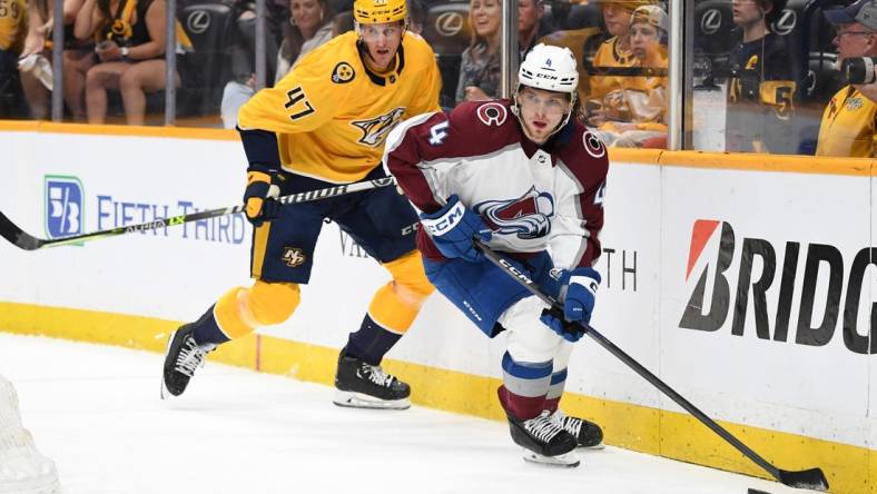 Apr 14, 2023; Nashville, Tennessee, USA; Colorado Avalanche defenseman Bowen Byram (4) skates with the puck against Nashville Predators right wing Michael McCarron (47) during the first period at Bridgestone Arena. Mandatory Credit: Christopher Hanewinckel-USA TODAY Sports