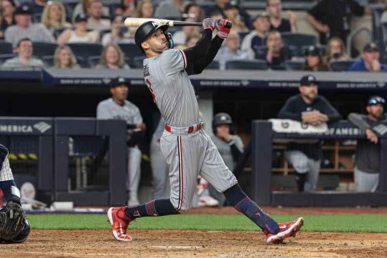 Apr 14, 2023; Bronx, New York, USA; Minnesota Twins shortstop Carlos Correa (4) looks up at his solo home run during the sixth inning against the New York Yankees at Yankee Stadium. Mandatory Credit: Vincent Carchietta-USA TODAY Sports