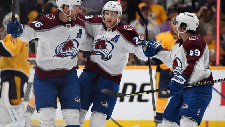 Apr 14, 2023; Nashville, Tennessee, USA; Colorado Avalanche center Nathan MacKinnon (29) celebrates with right wing Mikko Rantanen (96) and defenseman Samuel Girard (49) celebrate after scoring the game-winning goal during the third period against the Nashville Predators at Bridgestone Arena. Mandatory Credit: Christopher Hanewinckel-USA TODAY Sports