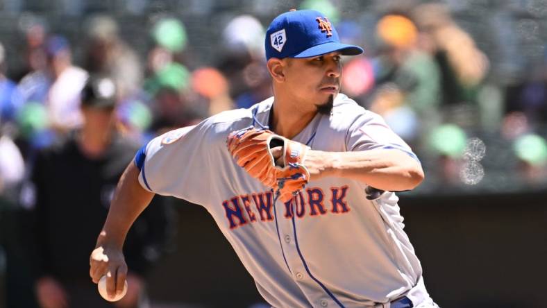 Apr 15, 2023; Oakland, California, USA; New York Mets starting pitcher Carlos Carrasco (59) throws against the Oakland Athletics during the first inning at RingCentral Coliseum. Mandatory Credit: Robert Edwards-USA TODAY Sports