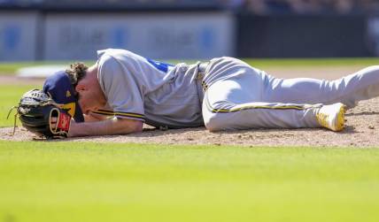 Apr 15, 2023; San Diego, California, USA;  Milwaukee Brewers relief pitcher Gus Varland lies on the ground after being hit by a line out by San Diego Padres third baseman Manny Machado (not pictured) during the eighth inningat Petco Park. Mandatory Credit: Ray Acevedo-USA TODAY Sports