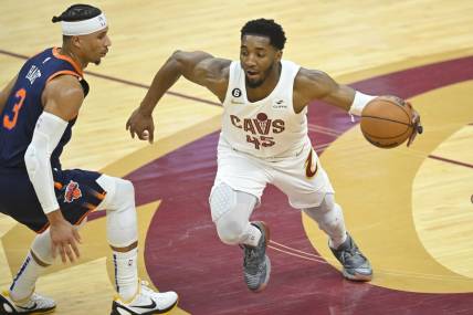 Apr 15, 2023; Cleveland, Ohio, USA; Cleveland Cavaliers guard Donovan Mitchell (45) dribbles beside New York Knicks guard Josh Hart (3) in the second quarter of game one of the 2023 NBA playoffs at Rocket Mortgage FieldHouse. Mandatory Credit: David Richard-USA TODAY Sports