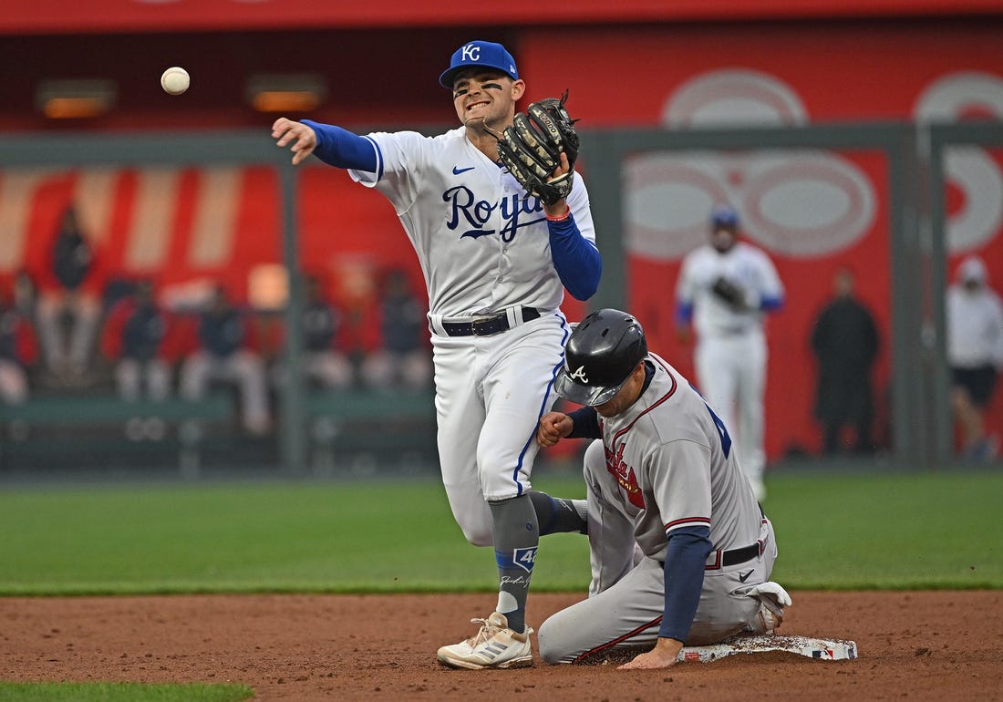 Apr 15, 2023; Kansas City, Missouri, USA;  Kansas City Royals second baseman Michael Massey (19) throws to first base for a double play over Atlanta Braves second baseman Ozzie Albies (1) during the third inning at Kauffman Stadium. Mandatory Credit: Peter Aiken-USA TODAY Sports