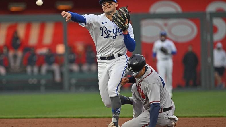 Apr 15, 2023; Kansas City, Missouri, USA;  Kansas City Royals second baseman Michael Massey (19) throws to first base for a double play over Atlanta Braves second baseman Ozzie Albies (1) during the third inning at Kauffman Stadium. Mandatory Credit: Peter Aiken-USA TODAY Sports