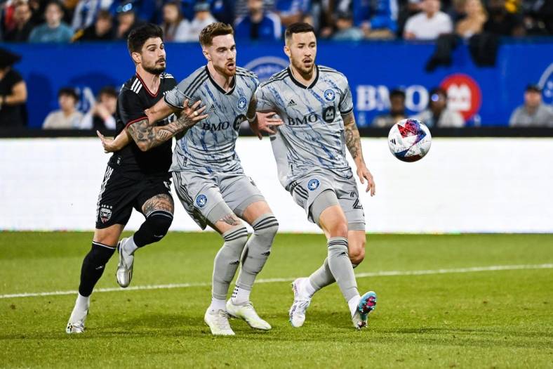 Apr 15, 2023; Montreal, Quebec, CAN; CF Montreal defender Joel Waterman (16) and defender Aaron Herrera (22) defend the ball against DC United forward Taxi Fountas (11) during the first half at Stade Saputo. Mandatory Credit: David Kirouac-USA TODAY Sports