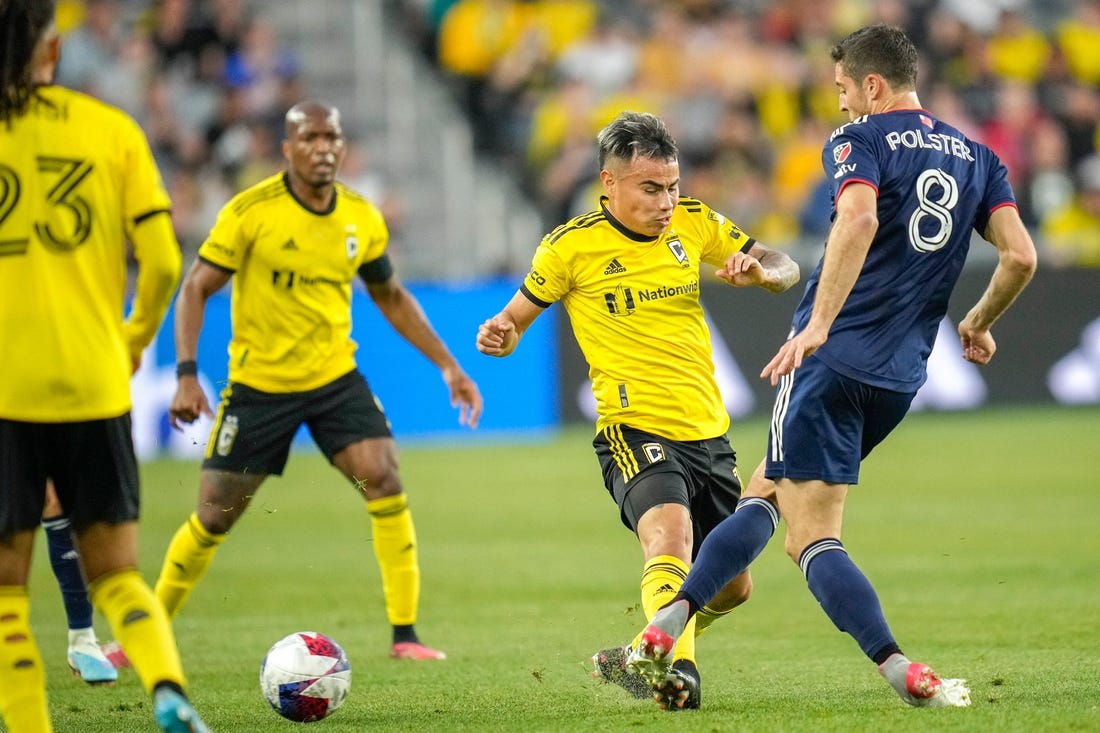 Apr 15, 2023; Columbus, Ohio, United States;  New England Revolution midfielder Matt Polster (8) kicks the ball away from Columbus Crew midfielder Lucas Zelarayan (10) during the first half of the MLS soccer game between Columbus Crew and New England Revolution at Lower.com Field on Saturday evening. Mandatory Credit: Joseph Scheller-The Columbus Dispatch

Mls Ceb Crew New England New England At Crew