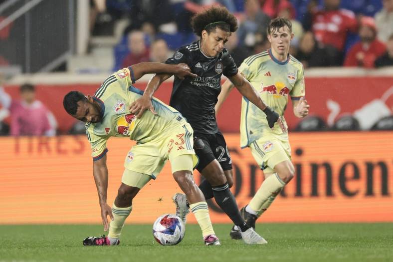 Apr 15, 2023; Harrison, New Jersey, USA; Houston Dynamo midfielder Adalberto Carrasquilla (20) plays the ball against New York Red Bulls midfielder Cristian Casseres Jr (23) during the first half at Red Bull Arena. Mandatory Credit: Vincent Carchietta-USA TODAY Sports