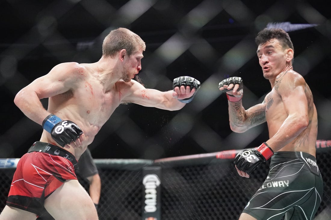 Apr 15, 2023; Kansas City, Missouri, USA; Max Holloway (red gloves) fights Arnold Allen (blue gloves) during UFC Fight Night at T-Mobile Center. Mandatory Credit: Denny Medley-USA TODAY Sports