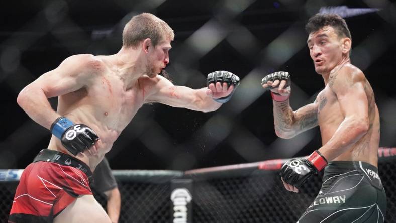 Apr 15, 2023; Kansas City, Missouri, USA; Max Holloway (red gloves) fights Arnold Allen (blue gloves) during UFC Fight Night at T-Mobile Center. Mandatory Credit: Denny Medley-USA TODAY Sports