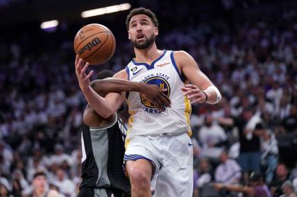 Apr 15, 2023; Sacramento, California, USA; Golden State Warriors guard Klay Thompson (11) is hit by Sacramento Kings forward Harrison Barnes (40) in the third quarter during game one of the 2023 NBA playoffs at the Golden 1 Center. Mandatory Credit: Cary Edmondson-USA TODAY Sports