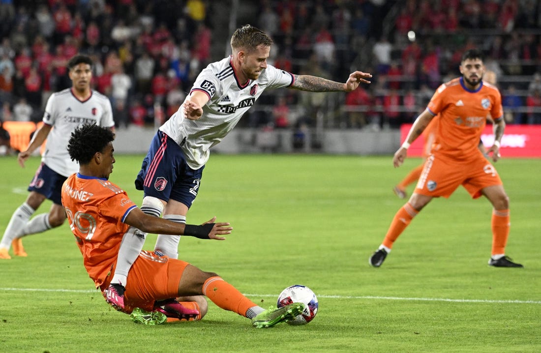 Apr 15, 2023; St. Louis, Missouri, USA; FC Cincinnati forward Arquimides Ordonez (29) and St. Louis City forward Rasmus Alm (21) battle for the ball during the first half at CITYPARK. Mandatory Credit: Scott Rovak-USA TODAY Sports