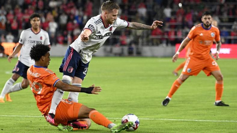 Apr 15, 2023; St. Louis, Missouri, USA; FC Cincinnati forward Arquimides Ordonez (29) and St. Louis City forward Rasmus Alm (21) battle for the ball during the first half at CITYPARK. Mandatory Credit: Scott Rovak-USA TODAY Sports