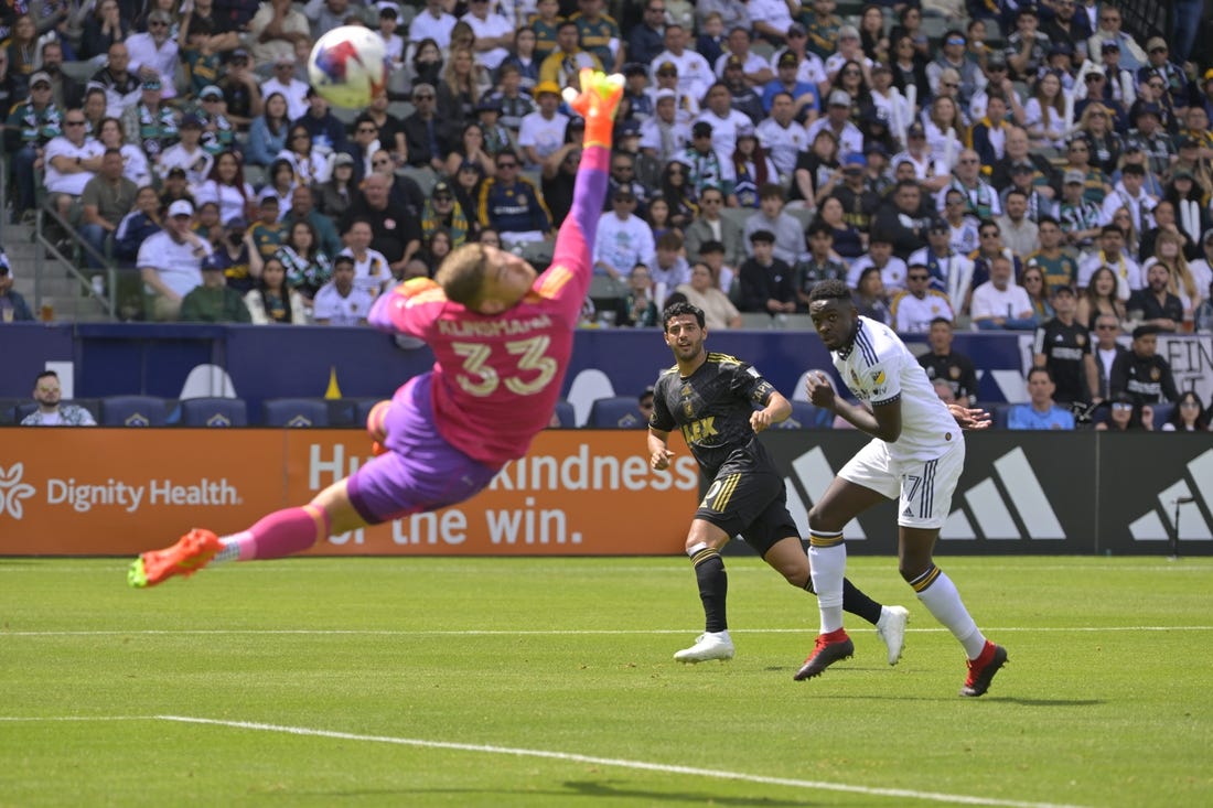 Apr 16, 2023; Carson, California, USA; Los Angeles FC forward Carlos Vela (10) scores a goal past Los Angeles Galaxy goalkeeper Jonathan Klinsmann and midfielder Memo Rodriguez (17) in the first half at Dignity Health Sports Park. Mandatory Credit: Jayne Kamin-Oncea-USA TODAY Sports